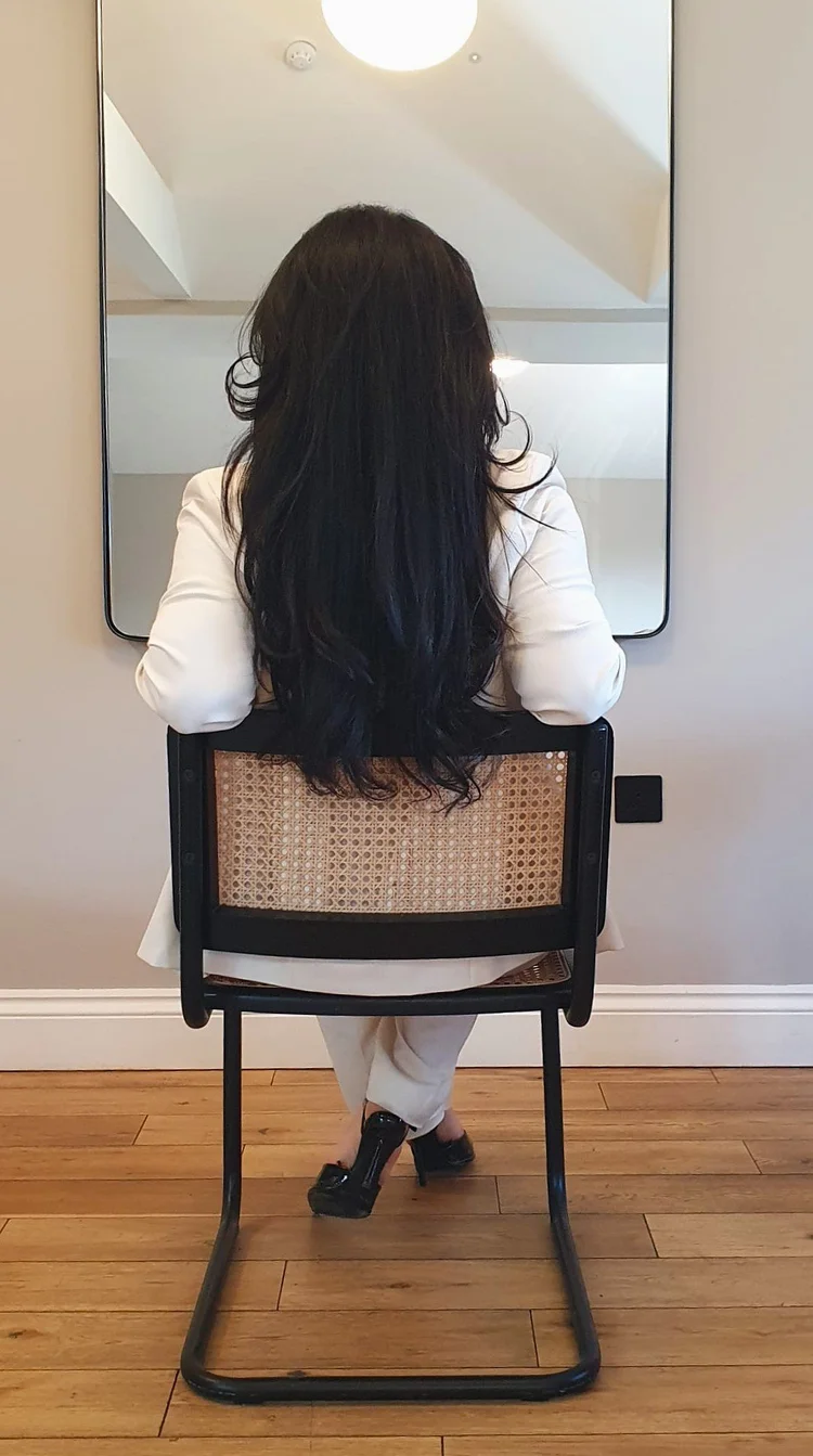 Lama seated in front of a mirror