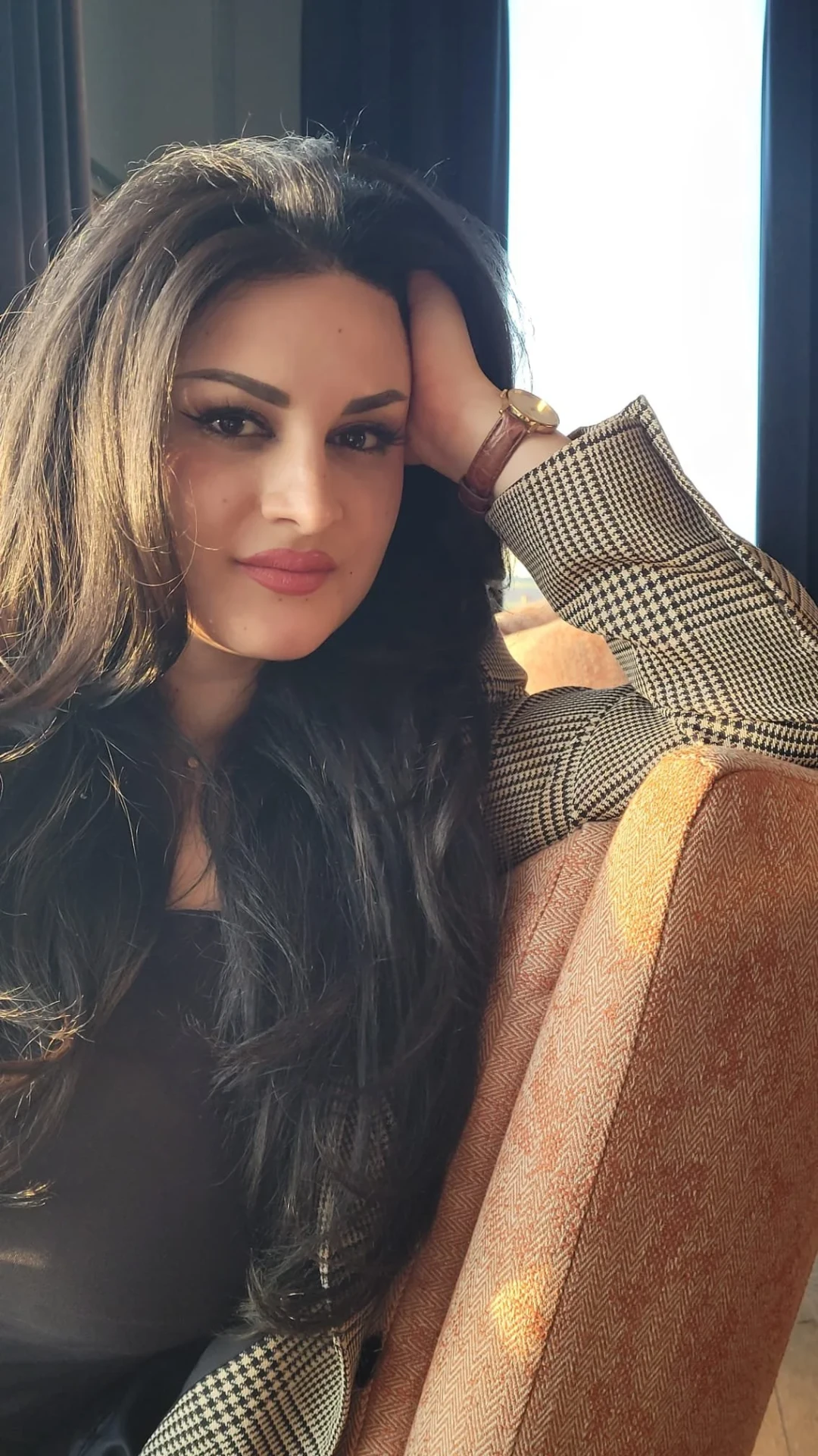 Lama Abou Daher seated by a window